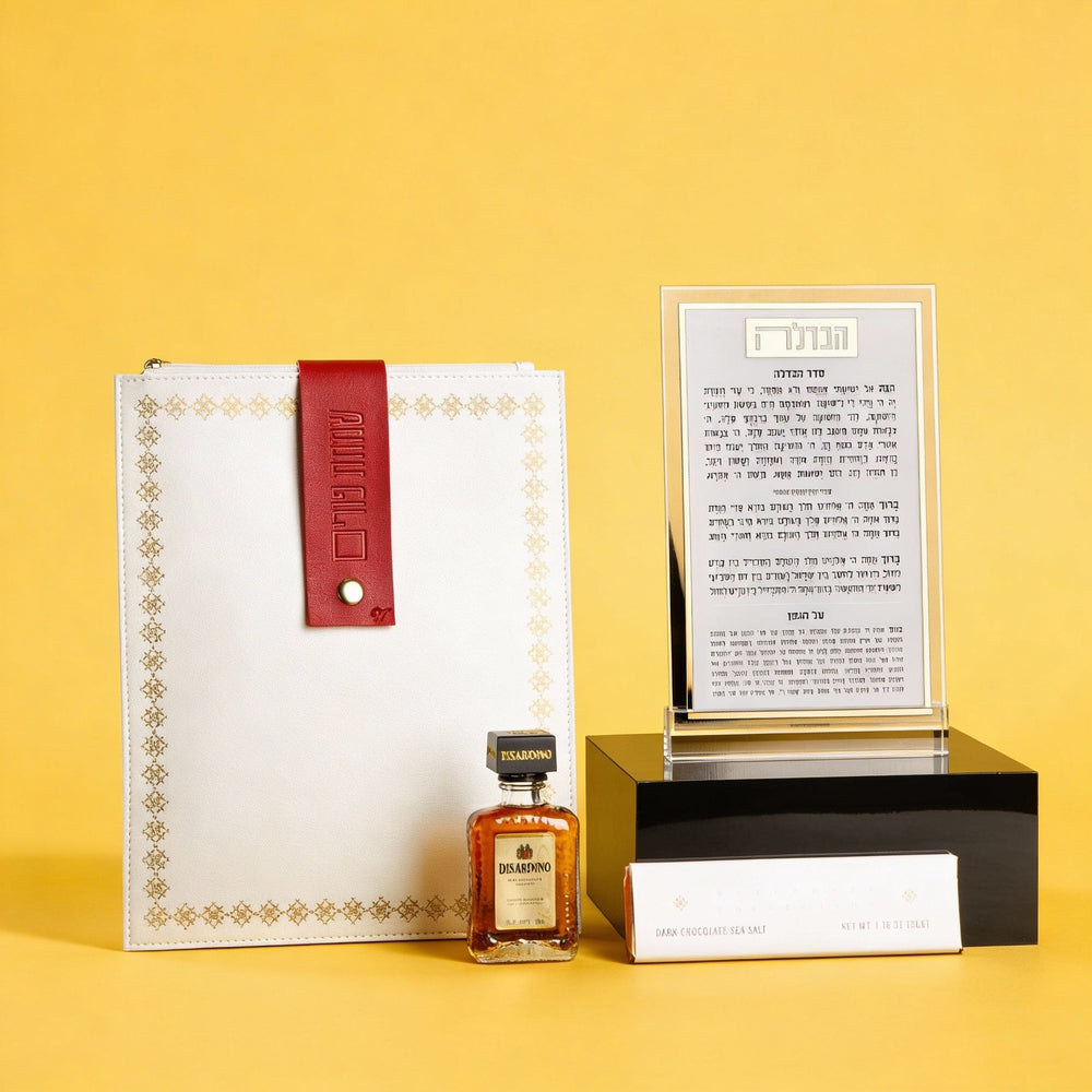 Elegant Mishloach Manot gift basket for Purim featuring premium wine, Hebrew-themed Judaica, and deluxe gift boxes