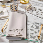 Onyx Butterfly Challah Board and Cover Set with cream linen cover featuring black butterfly design, displayed on white marble surface with gold accents and design sketches.