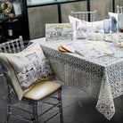 Painted Bais Hamikdash Pesach set displayed on a fully set Seder table, including matzah cover, Seder plate, afikomen bag, and decorative pillow with Jerusalem artwork and gold Hebrew text.
