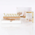 A Waterdale Collection Chanukah display - a painted Lucite menorah tray, a gold menorah, a printed brachos tabletop and a lighter, set for candle lighting