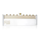 Painted by Batya Chanukah menorah set with cream ceramic base and brass candle holders, displayed against white background.