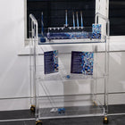 Waterdale Collection Painted Mosaic Chanukah set displayed on white shelving with blue ceramic pieces and matching towels.