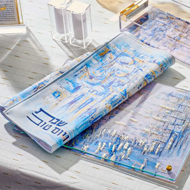Painted Yosefa Challah Cover with blue and gold Jerusalem artwork, Hebrew Shabbat Kodesh lettering, luxury Shabbos table decor, modern Judaica challah cover for Jewish home gift.