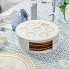 Pearlstone 3 Level Spinning Seder Plate with white and gold design, rotating Passover Seder plate with Hebrew Pesach labels and built-in matzah storage, modern Judaica Pesach table centerpiece.