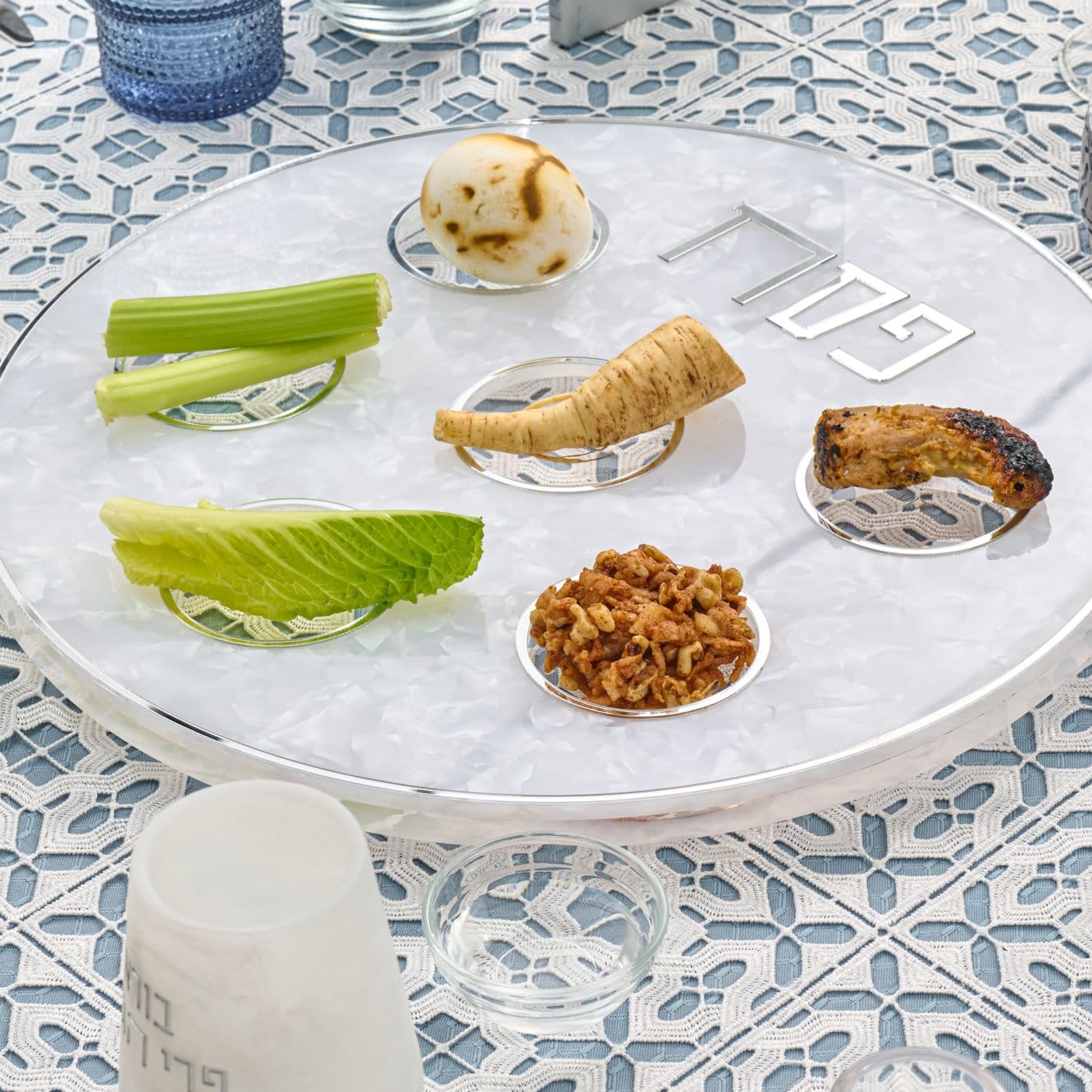 Pearlstone Seder Plate with white marble-look resin finish, six clear acrylic bowls, and silver accents for Passover.