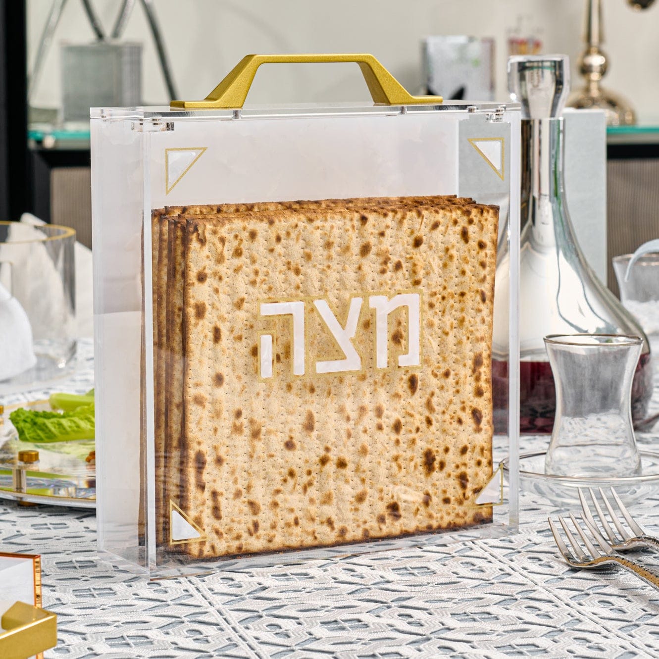 Pearlstone Square Matzah Box with clear acrylic and gold handle, modern Pesach matzah holder with Hebrew Matzah lettering, luxury Judaica Passover table decor and storage container.