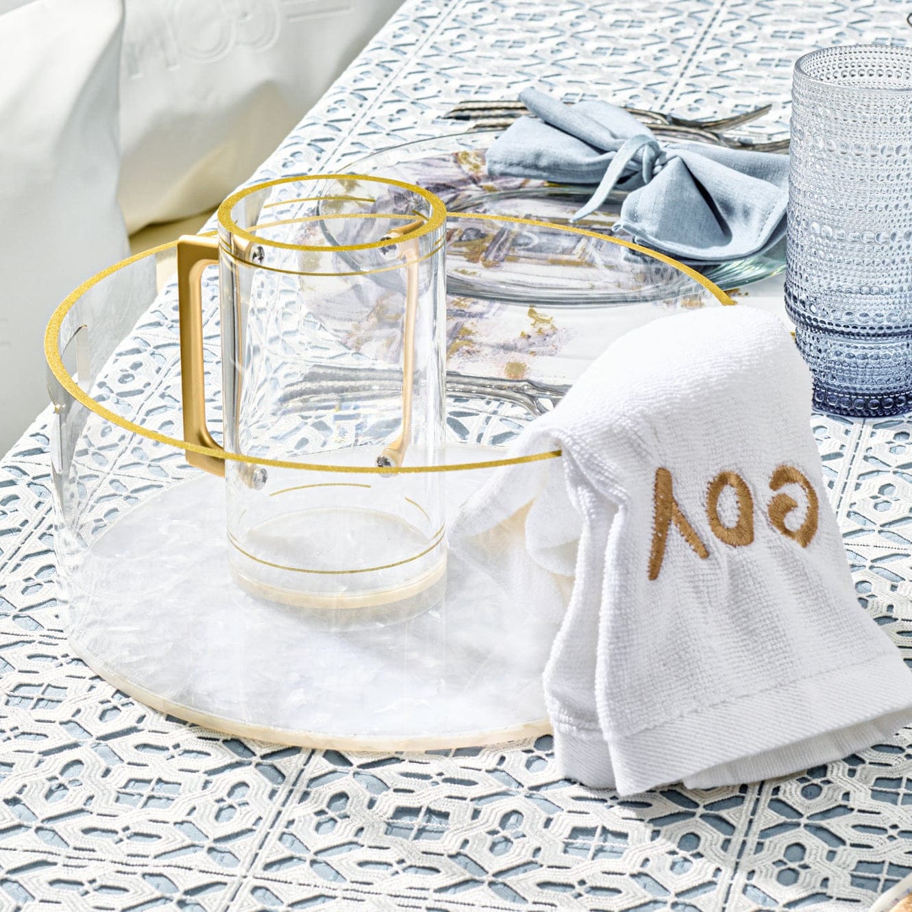 Lucite washing bowl set with a white towel and 'Pesach' text on a patterned surface. - AFH Bargains
