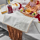 Pillow Script Challah Cover on a festive Rosh Hashanah table set with wine, honey, pomegranates, and symbolic foods.