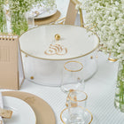 Elegant white lucite Regal Matzah Box with gold accents displayed on a table setting with spring flowers and place settings for Pesach.
