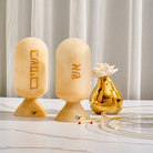 Beige marble-style resin besamim jar with Hebrew lettering displayed on elegant Havdalah table – Waterdale Collection