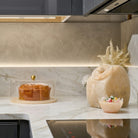 Modern Pearlstone resin cookie jar in a textured sand-taupe finish, featuring an airtight lid and minimalist arched silhouette; a durable, shatter-resistant stone-effect kitchen canister by Waterdale Collection