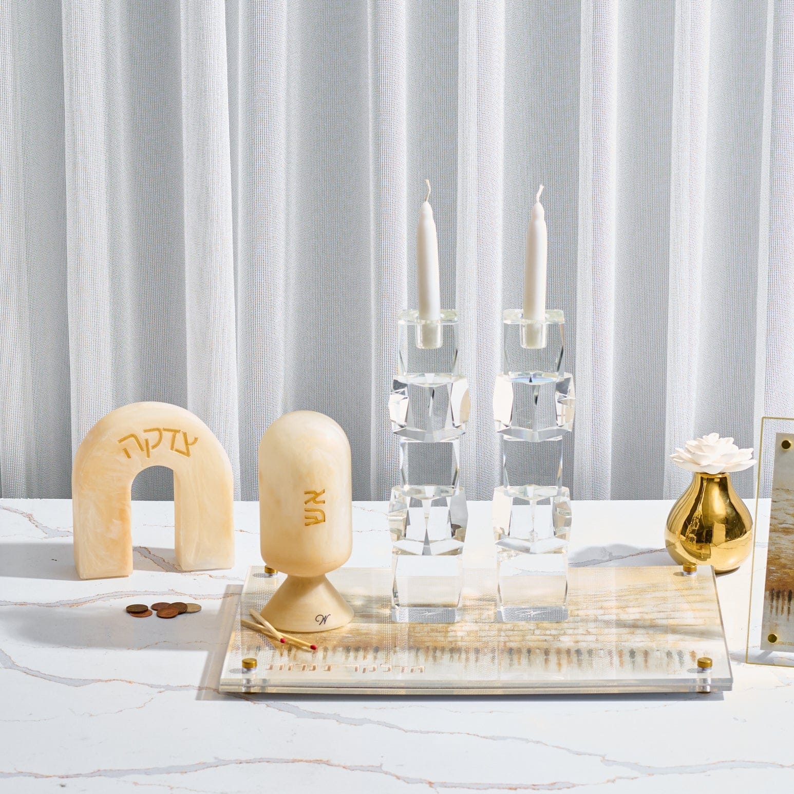 Beige marble-style resin match holder with Hebrew “אש” displayed on elegant Shabbat table setting – Waterdale Collection