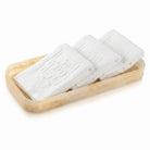 Three white towels on a resin tray with a white background - Waterdale Collection