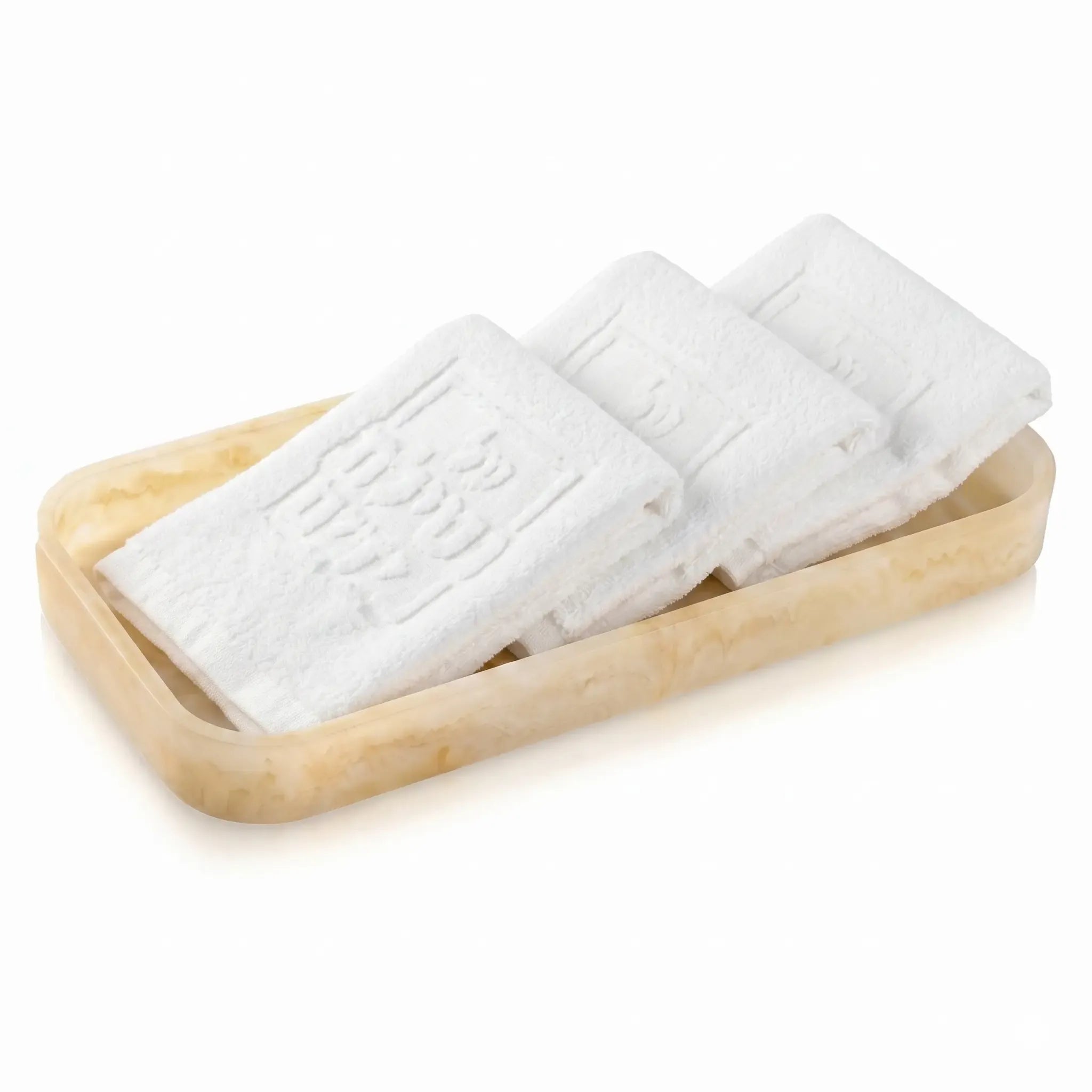 Three white towels on a resin tray with a white background - Waterdale Collection