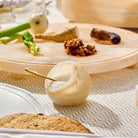 Beige resin salt cellar with spoon displayed on Passover Seder table – Waterdale Collection