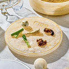Waterdale Collection resin seder plate with compartments holding traditional Passover foods including matzah, herbs, and charoset on white tablecloth.