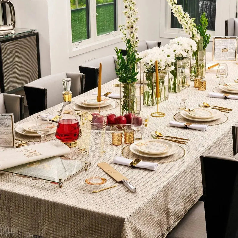 Rosh Hashana Classic Tablescape with white linens, gold accents, place settings, and floral centerpieces for holiday dining.