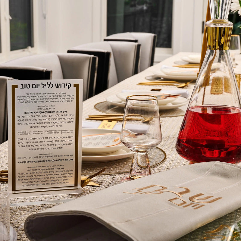Rosh Hashana Classic Tablescape with elegant white linens, gold accents, and traditional holiday place settings arranged on a formal dining table.