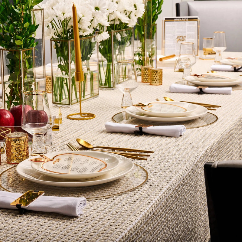 Rosh Hashana Classic Tablescape with cream linens, gold accents, white plates, and floral centerpieces by Waterdale Collection.