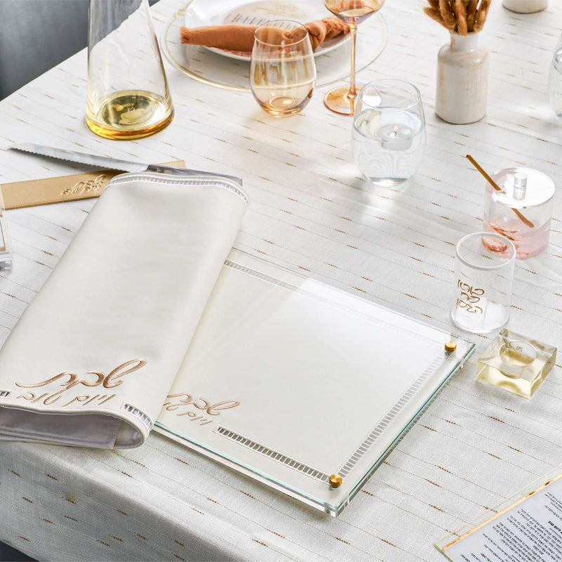 Rosh Hashanah rustic tablescape with marble placemats, wine glasses, and natural décor on white surface.
