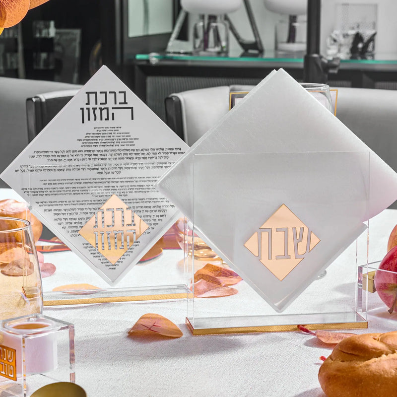 Rosh Hashanah 2025 Classic 2.0 tablescape featuring white geometric place cards and painted accents on a formal dining table setting.