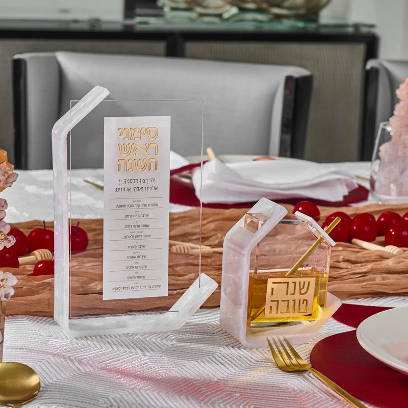Rosh Hashanah 2025 painted tablescape by Waterdale Collection featuring white candles, burgundy linens, gold accents, and place settings on a holiday table.