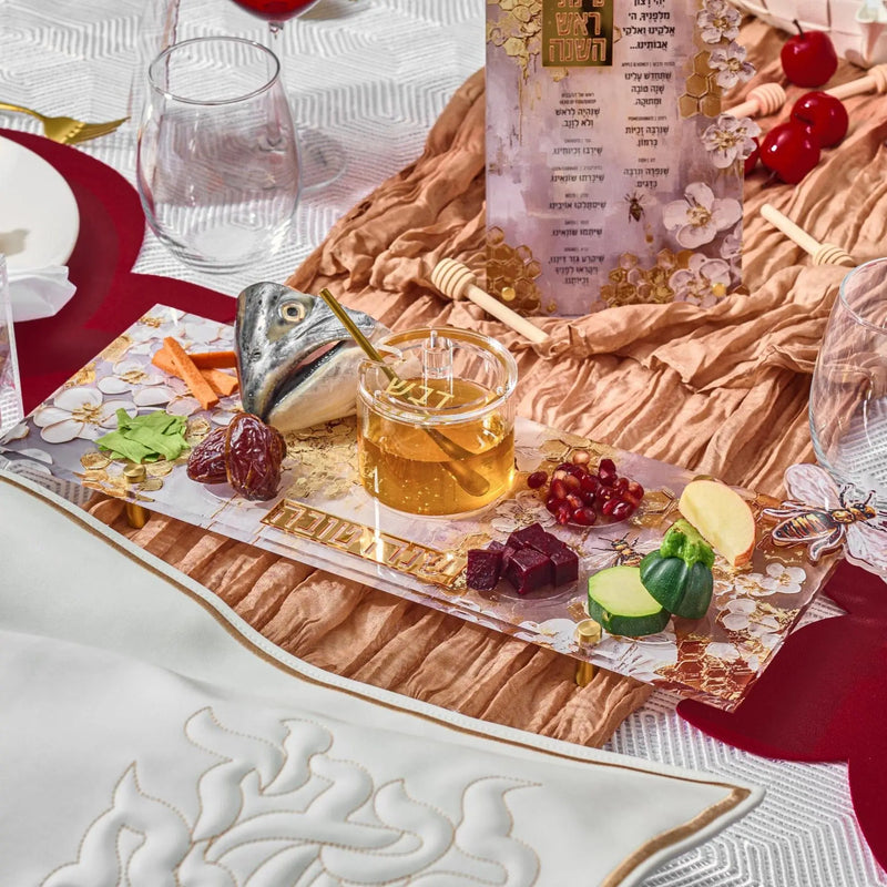 Rosh Hashanah 2025 painted tablescape with burgundy runner, gold accents, and traditional holiday place settings on white linens.