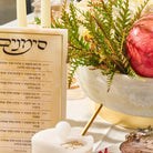 Marbled resin Simanim block standing on a Rosh Hashonah buffet