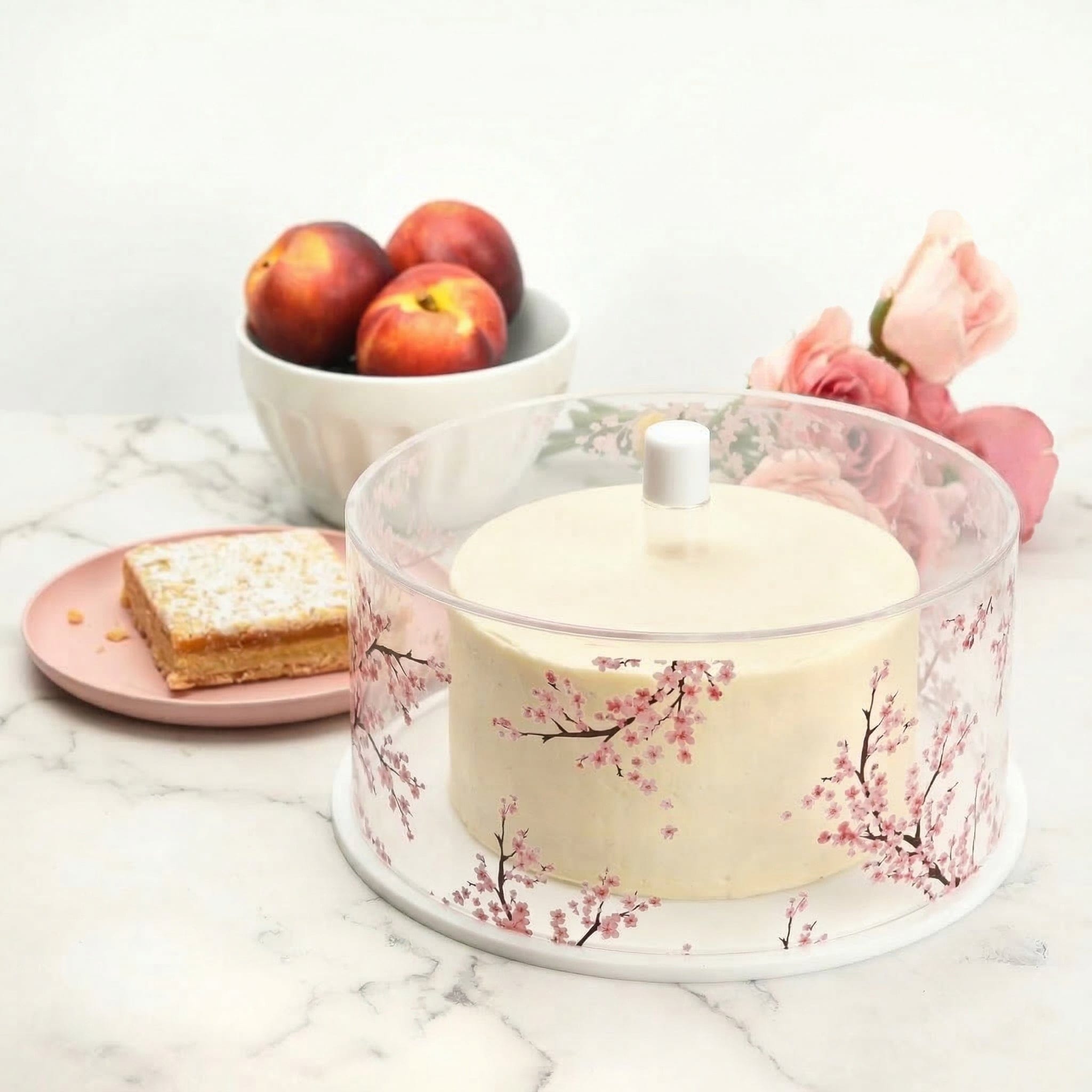Round cherry blossom cake dome displaying cake on an elegant table setting – Waterdale Collection
