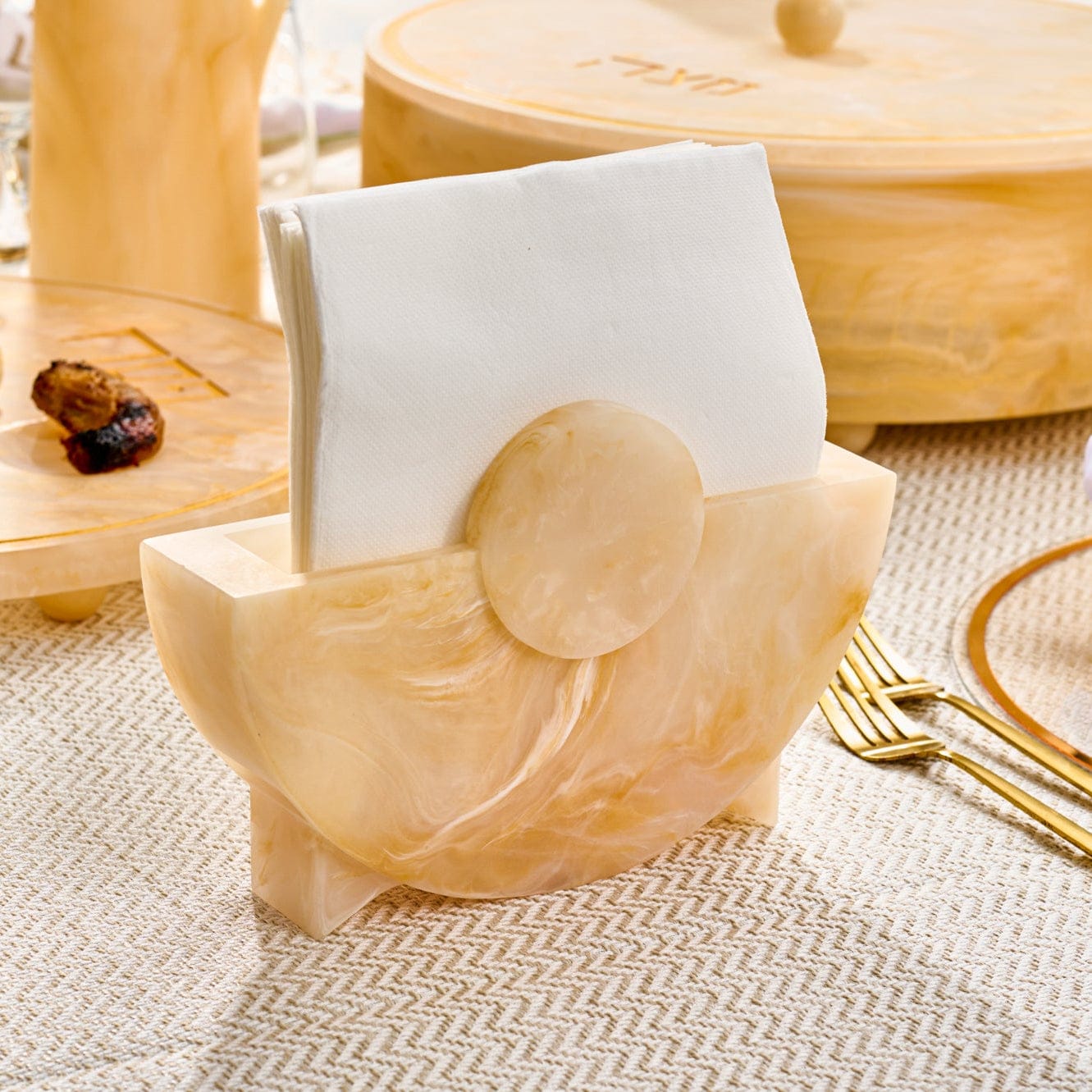 Beige marble-style round resin napkin holder styled on an elegant dining table – Waterdale Collection