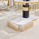 Napkin holder with white napkins on a table setting with a bottle of wine - waterdale collection