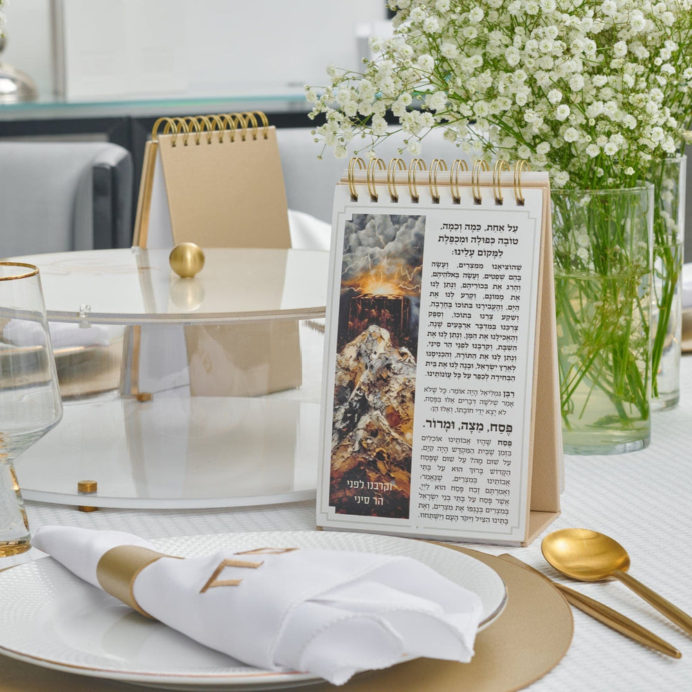 Gold Standing Leather Painted Haggadah on an elegant Shabbat table setting.