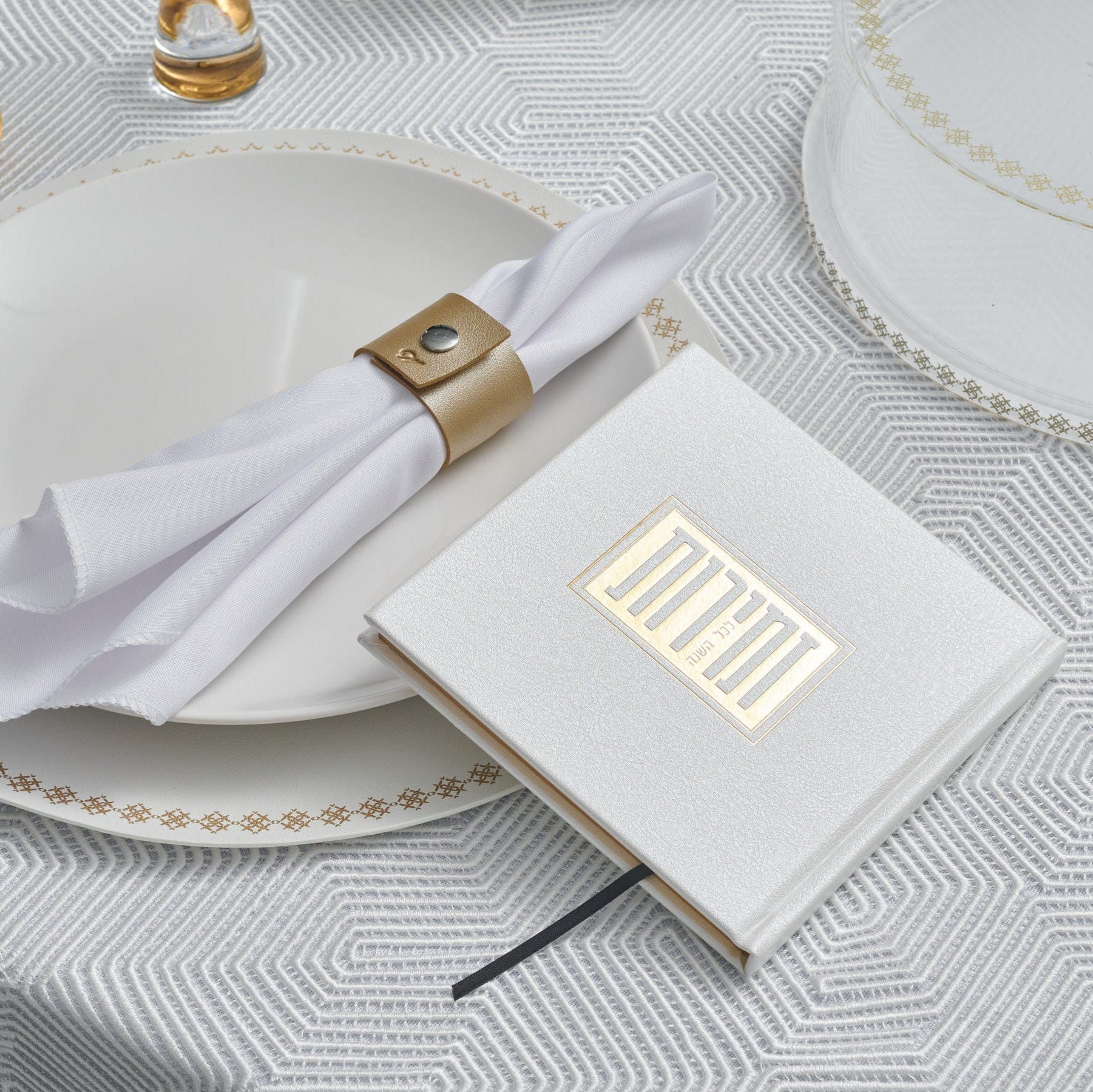 Suspended Shabbos & Yom Tov Zemiros Bencher Set on a table.