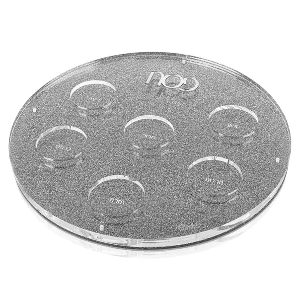 Clear lucite U Seder Plate with silver glitter accents and seven circular wells for traditional Passover items.