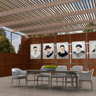 Light Gedolim vinyl sukkah decorations from Waterdale Collection, painted portraits on a wooden wall above a dining table in an outdoor sukkah, for Sukkot