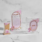 Watercolor Pillar Match Holder, including floral pink design, Hadlakat Nerot candle lighting prayer, and tzedakah box.