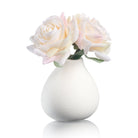 White faux floral teardrop vase with soft ivory and blush artificial roses.