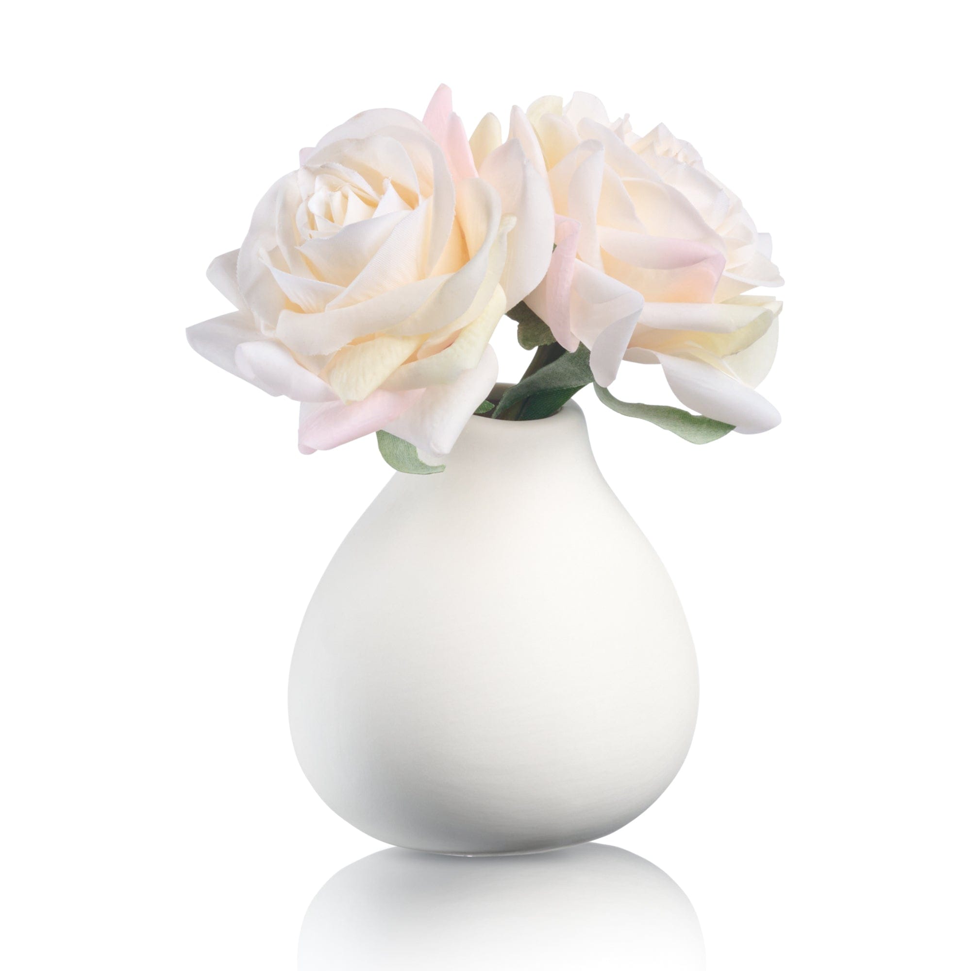 White faux floral teardrop vase with soft ivory and blush artificial roses.