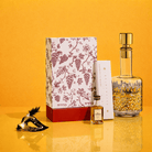 Premium leather Megillas Esther set with painted floral details and gold-accented glass decanter.