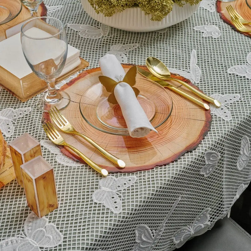 Wooden napkin holder with natural finish displayed on a table setting with folded napkins, gold utensils, and place cards for entertaining.