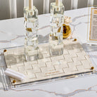 Woven Hadlokas Neiros Tray in clear acrylic with cream woven leather insert and gold Hebrew lettering, modern Shabbat candle lighting tray, elegant Jewish home decor centerpiece.