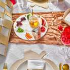 Gold Woven Simanim Tray with fish, honey dish, and other items on top of it in a Rosh Hashanah table setting