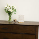 Woven Tzedakah Box on the buffet table with flower vase